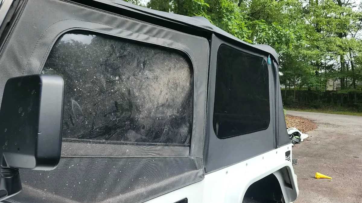 Jeep soft top showing dirty untreated material beside the cleaned revitalized result